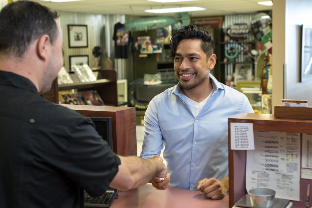 #16 Customer shaking hands Pawn shop employee shaking hands with a customer