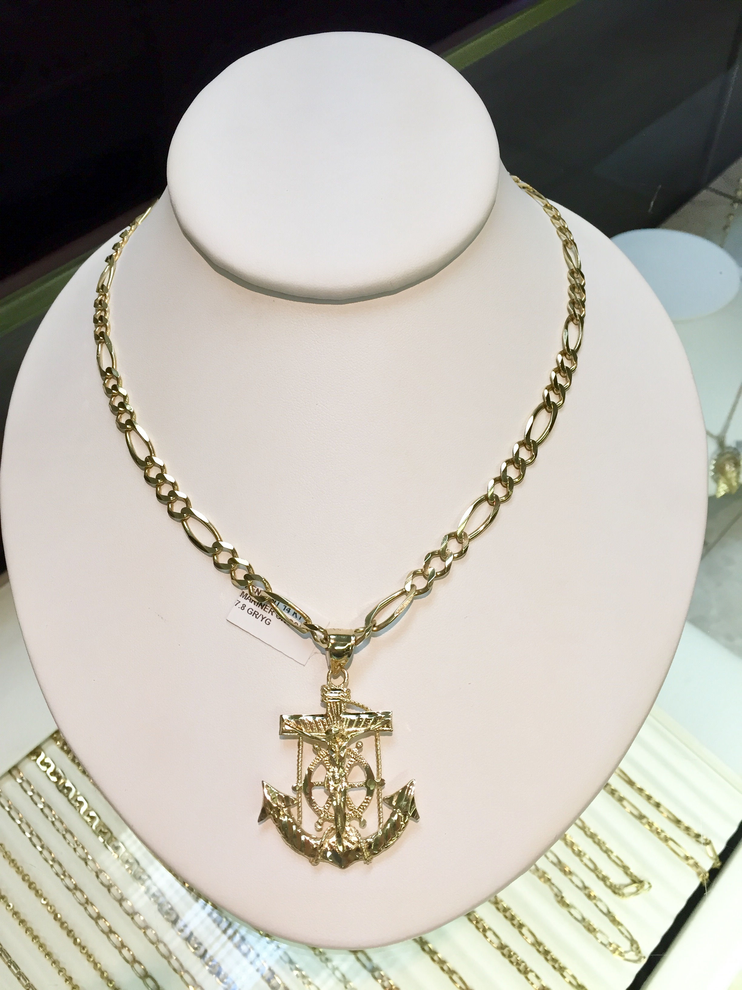 Gold chain and gold cross in our Kansas City jewelry store